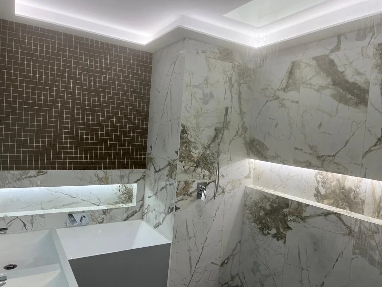 Luxury bathroom plastering with marble feature wall and integrated LED strip lighting, Sydney